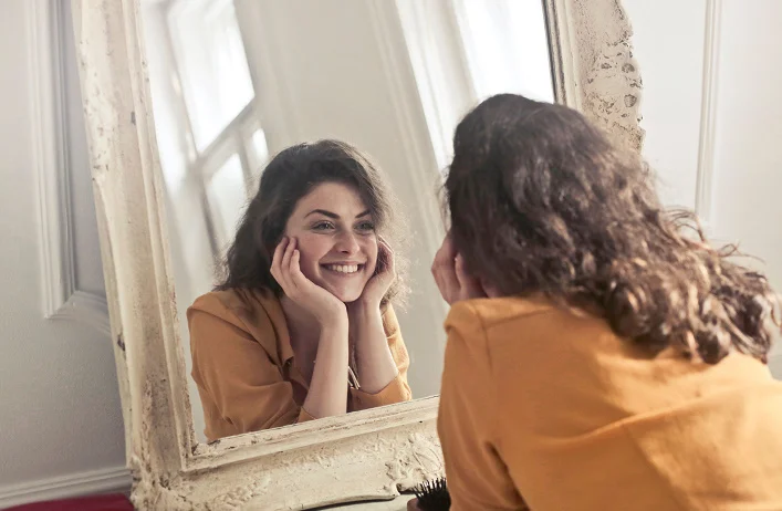 βPortrait of a confident individual with a glowing makeup look and a positive expression.β