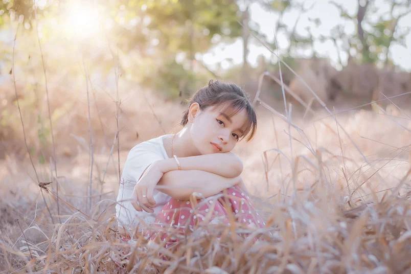Dreamy pastel sky with a girl daydreaming on a mountain viewpoint, featuring Daydream Captions Instagram ideas.